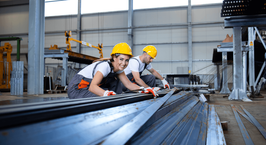 written by:, industrial workers working factory hall with metal